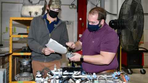 Engineers examine APU filter