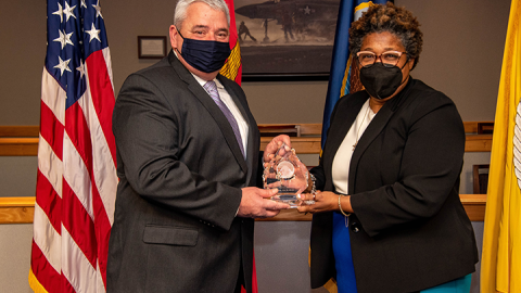 Deputy Assistant Secretary of Defense for Product Support Lisa P. Smith (right) presents Byrd with the 2021 Office of the Secretary of Defense for Acquisition and Sustainment PSM of the Year (Major Defense Acquisition Program, Acquisition Category 1) award. 
