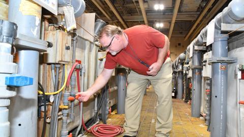 James Small, a blade and vane repairer at Fleet Readiness Center East (FRCE), checks water valves at building 4225. According to FRCE environmental officials, efforts to cut industrial wastewater generation have resulted in reductions of more than sixty thousand gallons per day in Building 4225 alone. Last year FRCE reduced its total industrial wastewater generation by 45%, exceeding its goal of achieving a 30% reduction in 2021. 