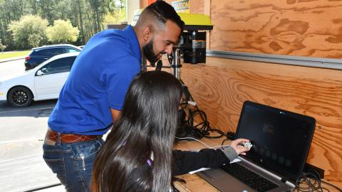 Engineer helps student program computer