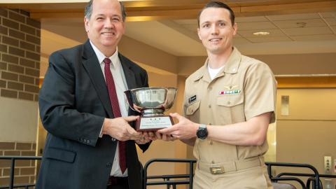 Cmdr. Dan Button accepts NAVAIR Commander's Award from Tom Rudowsky, NAVAIR deputy commander.
