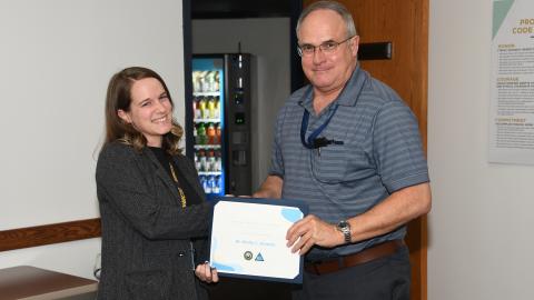 Dr. Emily Anania accepts certificate from Mike Merritt. 