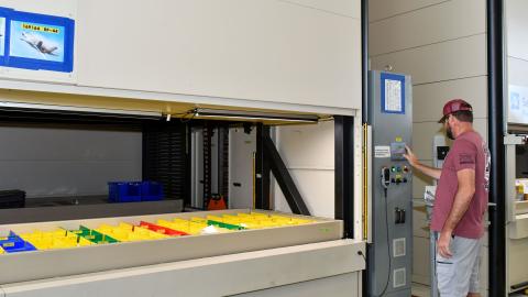 Man stands in front of machine 