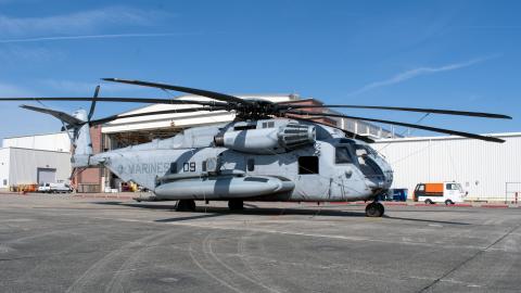 H-53 helicopter outside in front of an aircraft hangar