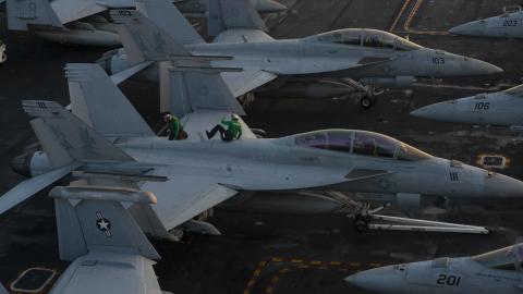 Sailors conduct maintenance on an F/A-18F Super Hornet, from the "Fighting Redcocks" of Strike Fighter Squadron (VFA-22), on the flight deck of USS Nimitz (CVN 68) 