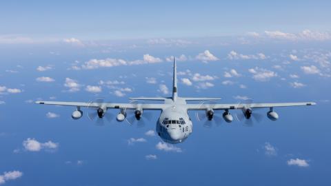 KC-130J Super Hercules Airplane Flying in a Blue Sky with Clouds