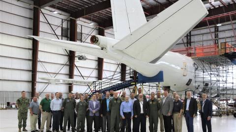 Group standing front of the E-6B Mercury prior to its delivery back to the Navy.