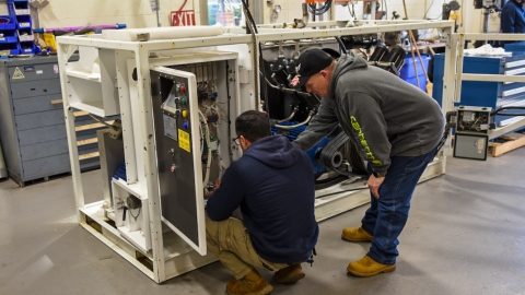 Team members work on a piece of cryogenic equipment at NAWCAD Lakehurst