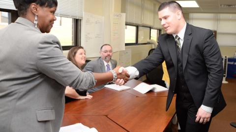 Mock interview participants shake hands