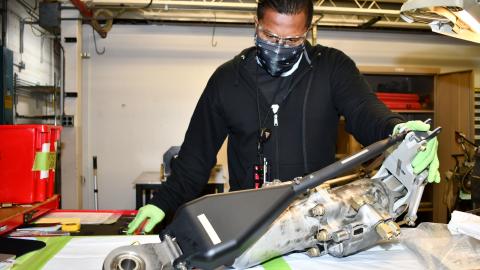 Man assembles H-53 helicopter primary servo cylinder