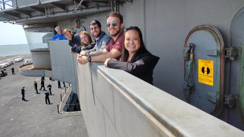 Team members pose on ship trip