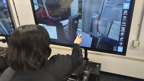 Sailor in black shirt training on a virtual touch-screen