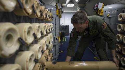 Sailor loads a sonobuoy aboard a P-8