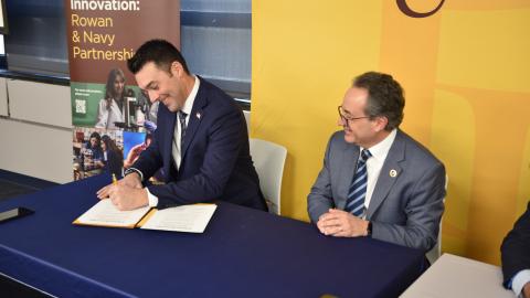 Joe Hader from NAWCAD Lakehurst signs partnership agreement with Rowan University
