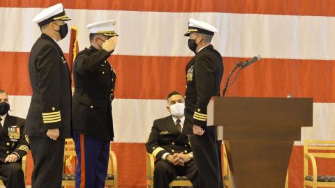 An incoming commanding officer salutes during a change of command ceremony.
