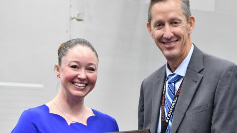 man and woman smiling holding an award